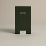 Dark green box labeled ‘FORGRAVE Fine Tea Leaves and Tisanes, 001 Green Blend Smoking Jacket on a beige background.