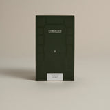 Dark green box labeled ‘FORGRAVE Fine Tea Leaves and Tisanes, 001 Green Blend Smoking Jacket on a beige background.