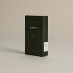 Dark green box of ‘FORGRAVE Fine Tea Leaves and Tisanes, 001 Smoking Jacket’ with minimalist design on a beige background.