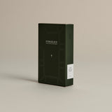 Dark green box of ‘FORGRAVE Fine Tea Leaves and Tisanes, 001 Smoking Jacket’ with minimalist design on a beige background.