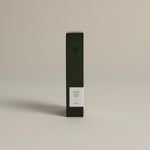 Minimalist dark green box labeled ‘002 Bright Side – Energy’ by FORGRAVE, standing upright on a beige background.