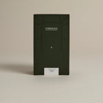 Dark green box labeled ‘FORGRAVE Fine Tea Leaves and Tisanes, 002 Black Blend Bright Side on a beige background.