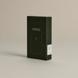 Dark green box of ‘FORGRAVE Fine Tea Leaves and Tisanes, 002 Bright side’ with minimalist design on a beige background.