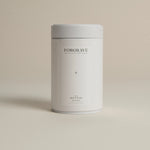 White tea canister labeled ‘003 Boy's Club Black Blend’ on a beige background.