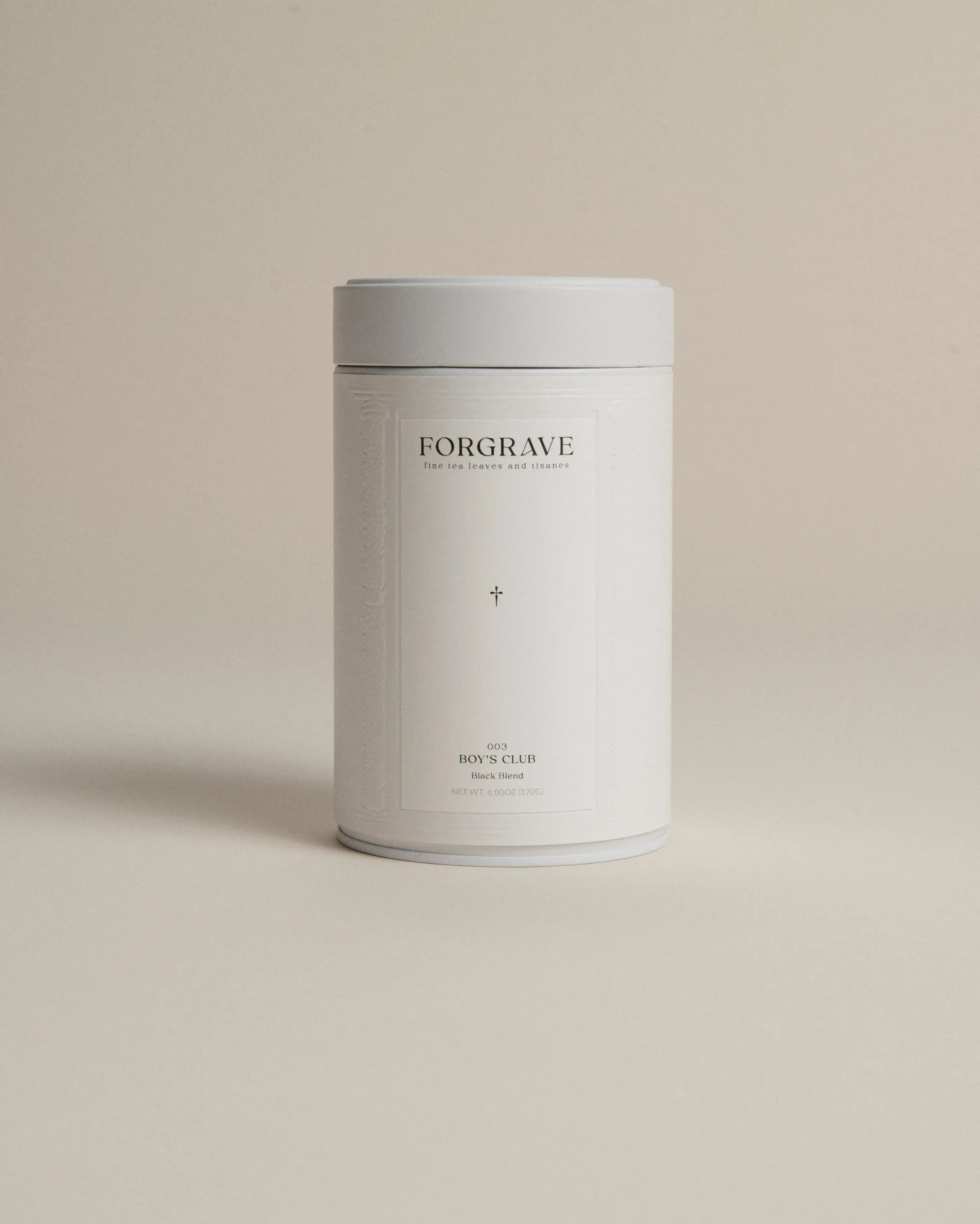 White tea canister labeled ‘003 Boy's Club Black Blend’ on a beige background.