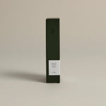Minimalist dark green box labeled ‘003 Boy's Club– Energy’ by FORGRAVE, standing upright on a beige background.