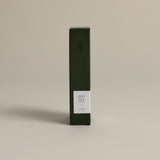 Minimalist dark green box labeled ‘003 Boy's Club– Energy’ by FORGRAVE, standing upright on a beige background.