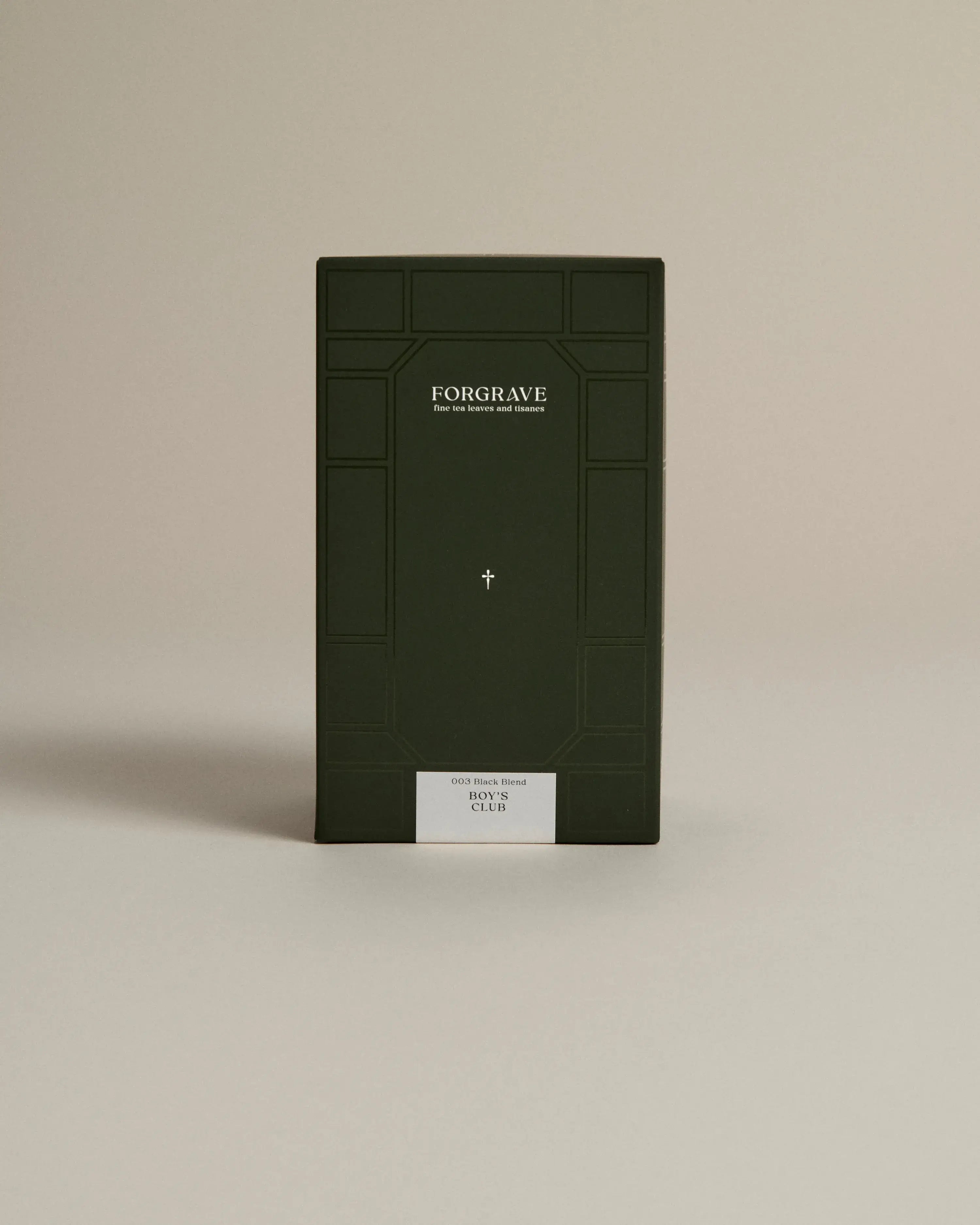 Dark green box labeled ‘FORGRAVE Fine Tea Leaves and Tisanes, 003 Black Blend Boy's Club on a beige background.