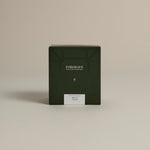 Dark green box labeled ‘FORGRAVE Fine Tea Leaves and Tisanes, 003 Black Blend Boy's Club on a beige background.