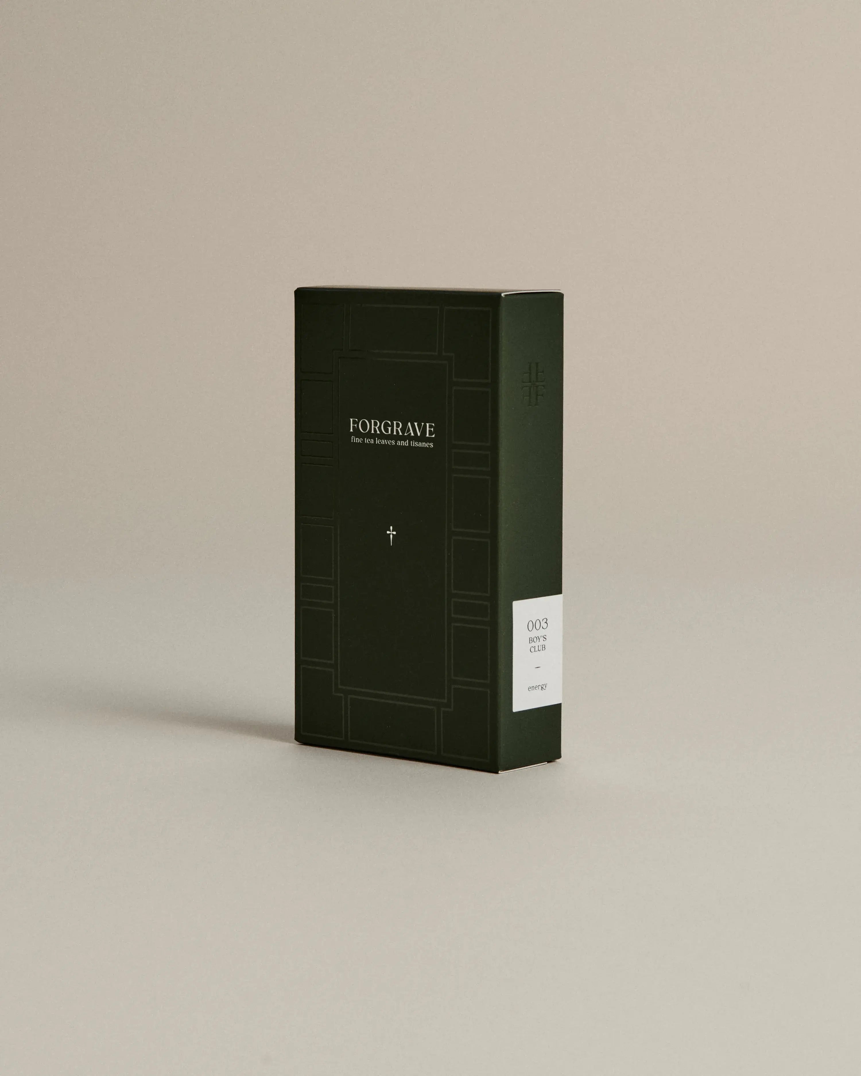 Dark green box of ‘FORGRAVE Fine Tea Leaves and Tisanes, 003 Boy's Club’ with minimalist design on a beige background.