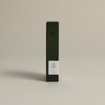 Minimalist dark green box labeled ‘004 Avant Garden – Focus’ by FORGRAVE, standing upright on a beige background.