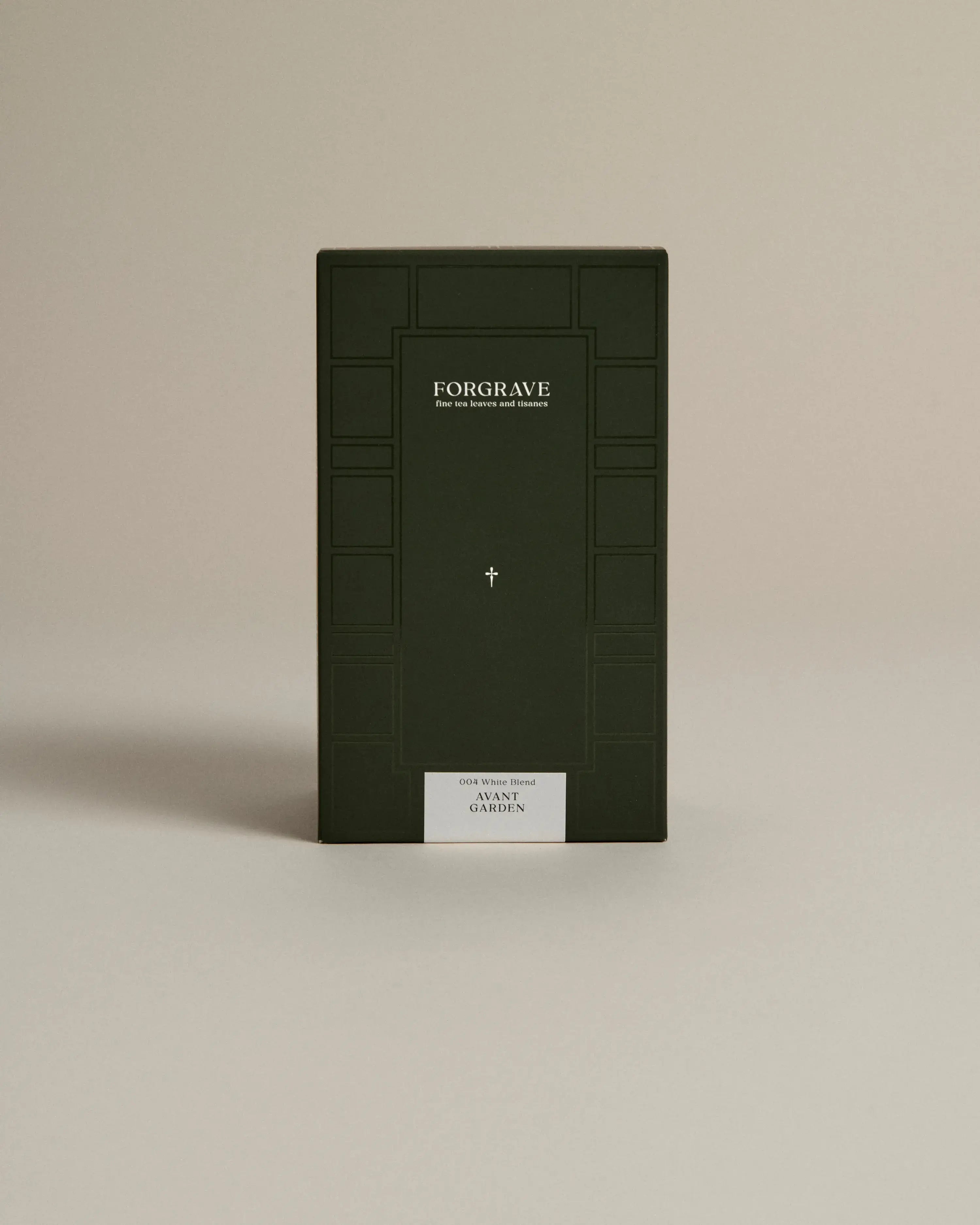 Dark green box labeled ‘FORGRAVE Fine Tea Leaves and Tisanes, 004 White Blend Avant Garden on a beige background.