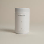 White tea canister labeled ‘005 Mint Mantra White Blend’ on a beige background.