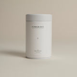 White tea canister labeled ‘005 Mint Mantra White Blend’ on a beige background.