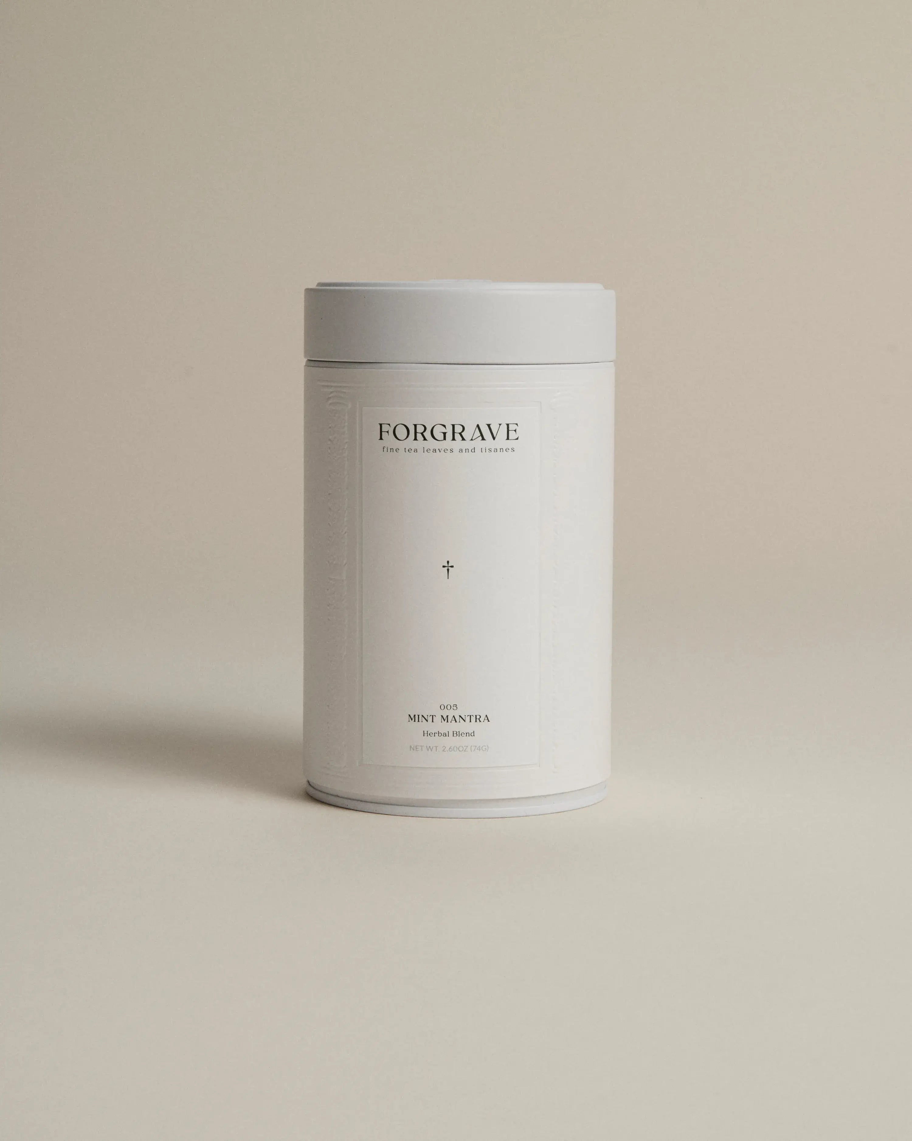 White tea canister labeled ‘005 Mint Mantra White Blend’ on a beige background.
