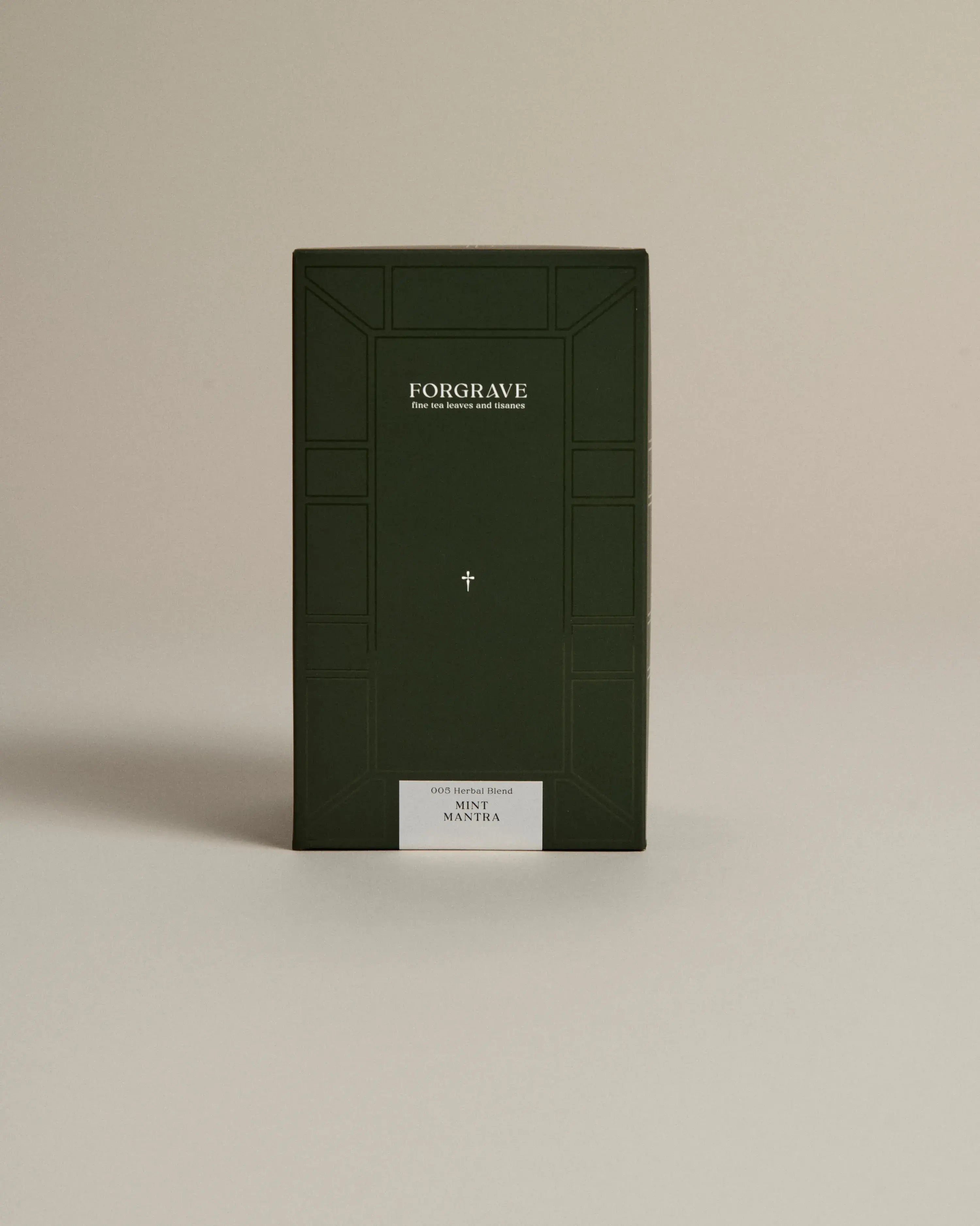 Dark green box labeled ‘FORGRAVE Fine Tea Leaves and Tisanes, 005 Herbal Blend Mint Mantra on a beige background.