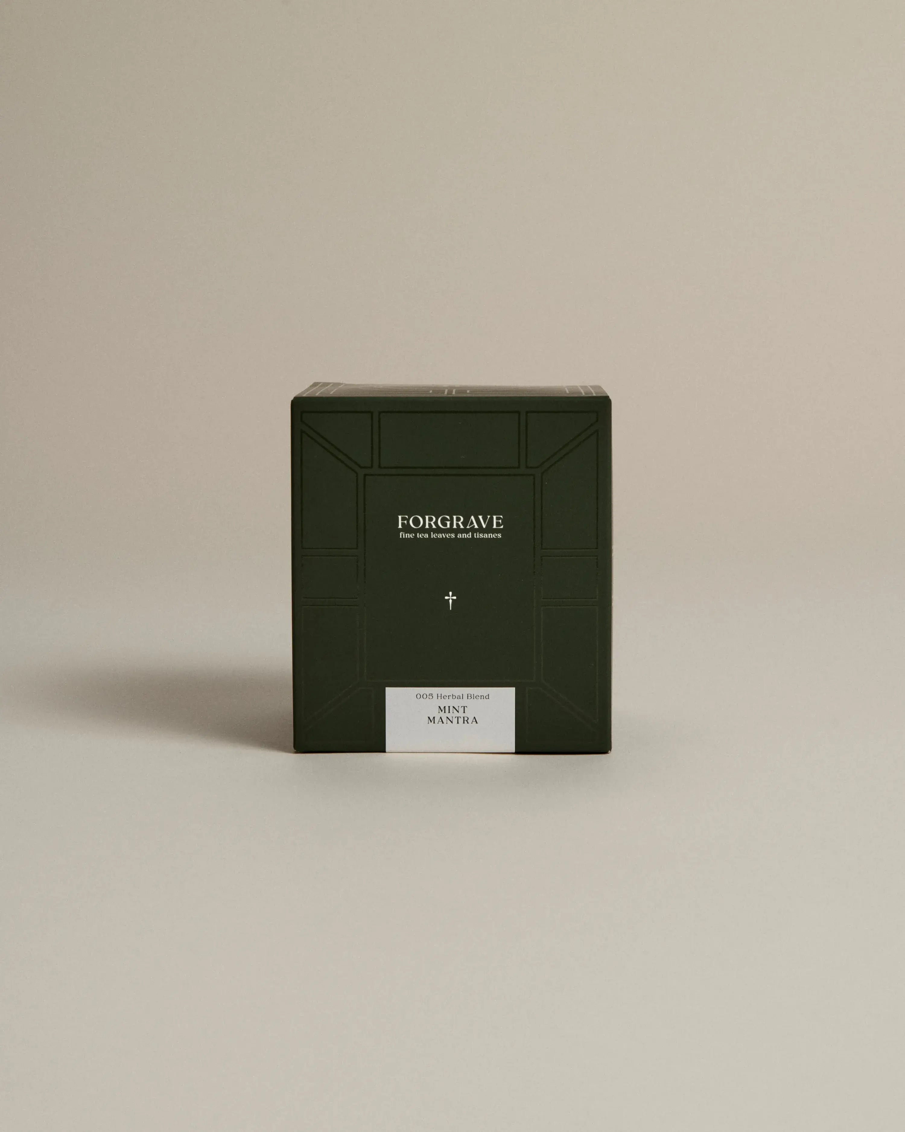 Dark green box labeled ‘FORGRAVE Fine Tea Leaves and Tisanes, 005 Herbal Blend Mint Mantra’ on a beige background.