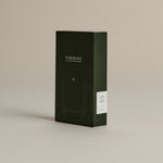 Dark green box of ‘FORGRAVE Fine Tea Leaves and Tisanes, 005 Mint Mantra’ with minimalist design on a beige background.