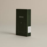 Dark green box of ‘FORGRAVE Fine Tea Leaves and Tisanes, 005 Mint Mantra’ with minimalist design on a beige background.
