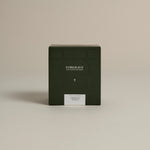 Dark green box labeled ‘FORGRAVE Fine Tea Leaves and Tisanes, 001 Green Blend Smoking Jacket on a beige background.