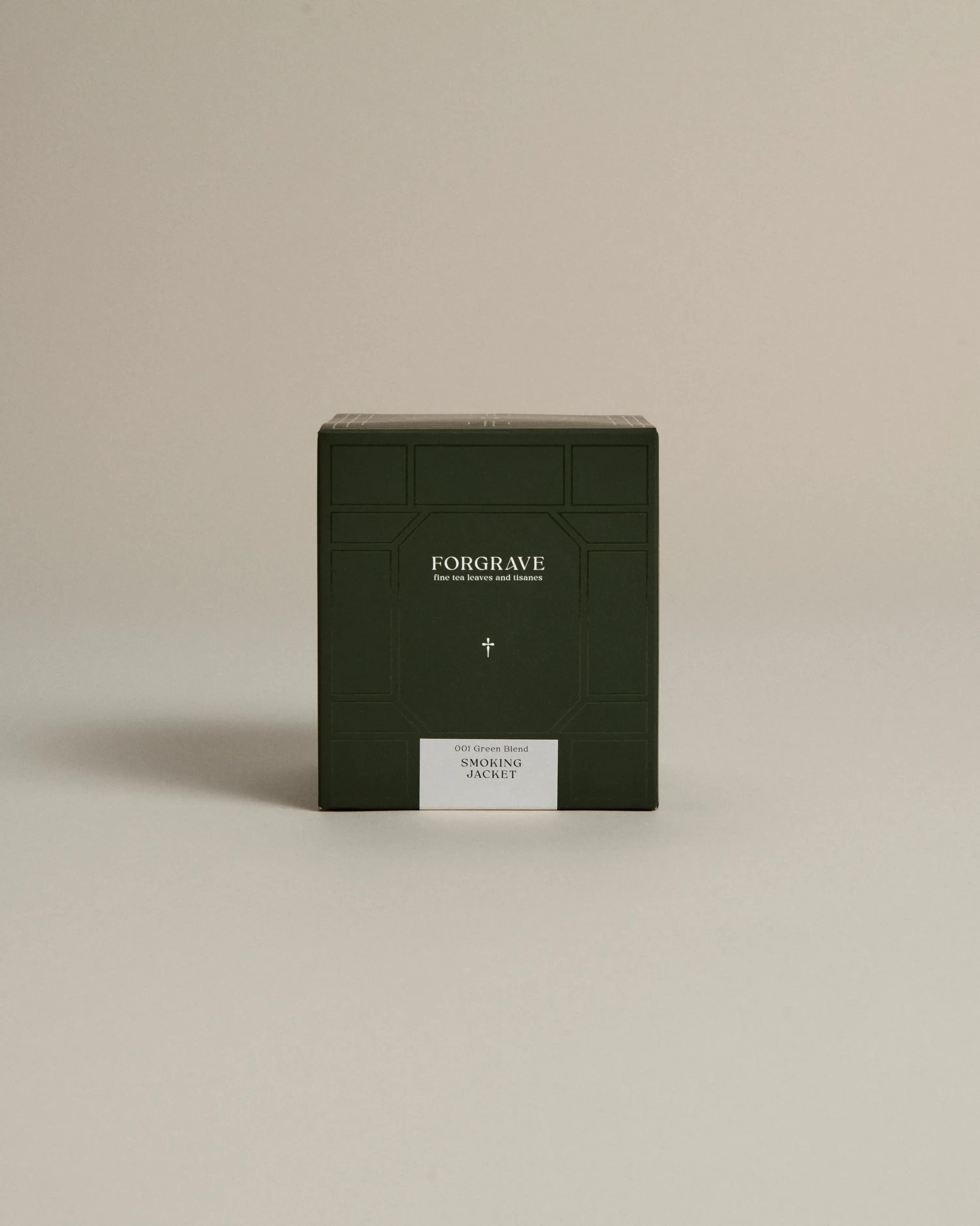 Dark green box labeled ‘FORGRAVE Fine Tea Leaves and Tisanes, 001 Green Blend Smoking Jacket on a beige background.