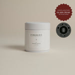 White tea canister labeled ‘001 Smoking Jacket Green Blend’ on a beige background.