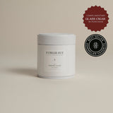 White tea canister labeled ‘001 Smoking Jacket Green Blend’ on a beige background.