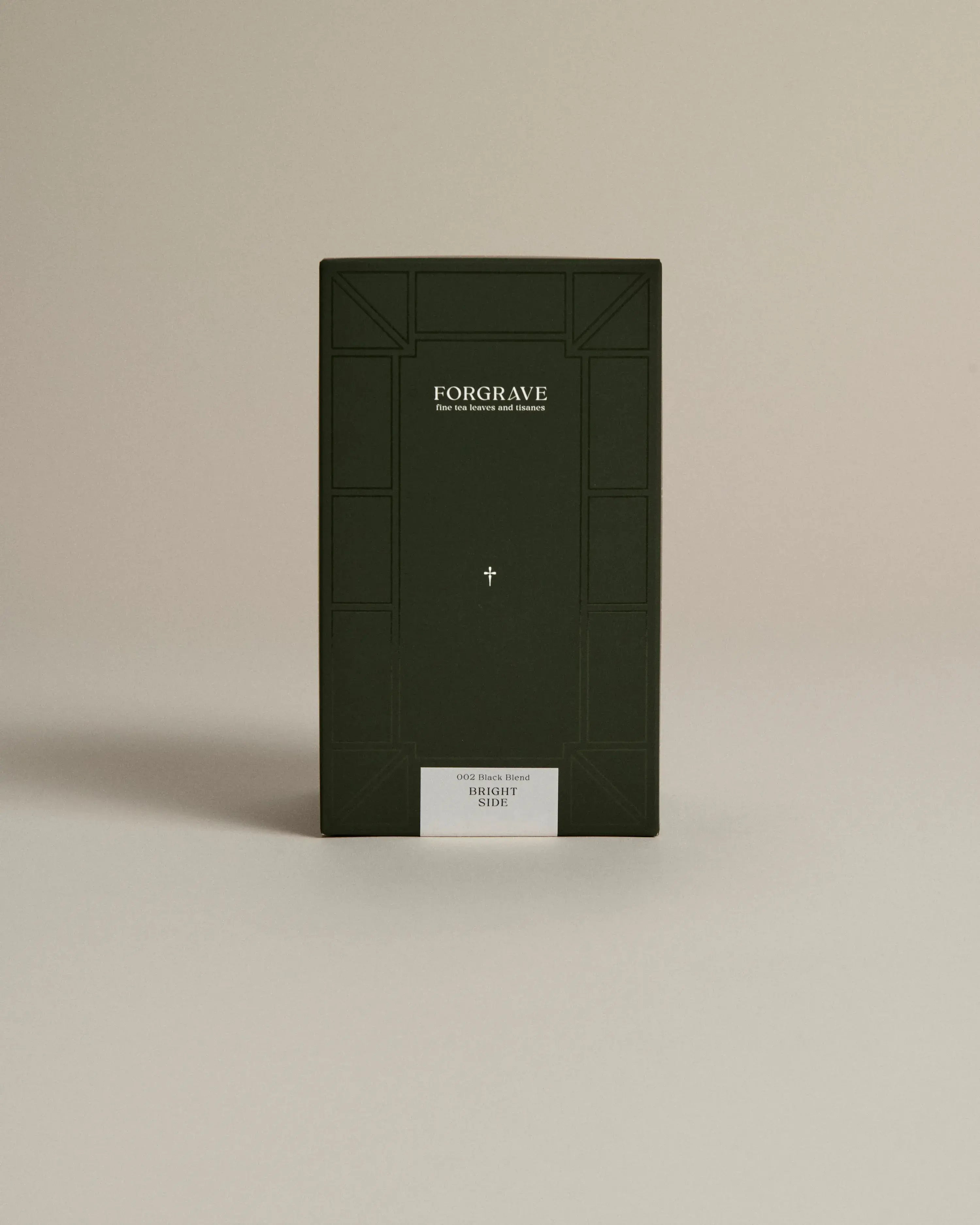 Dark green box labeled ‘FORGRAVE Fine Tea Leaves and Tisanes, 002 Black Blend Bright Side on a beige background.