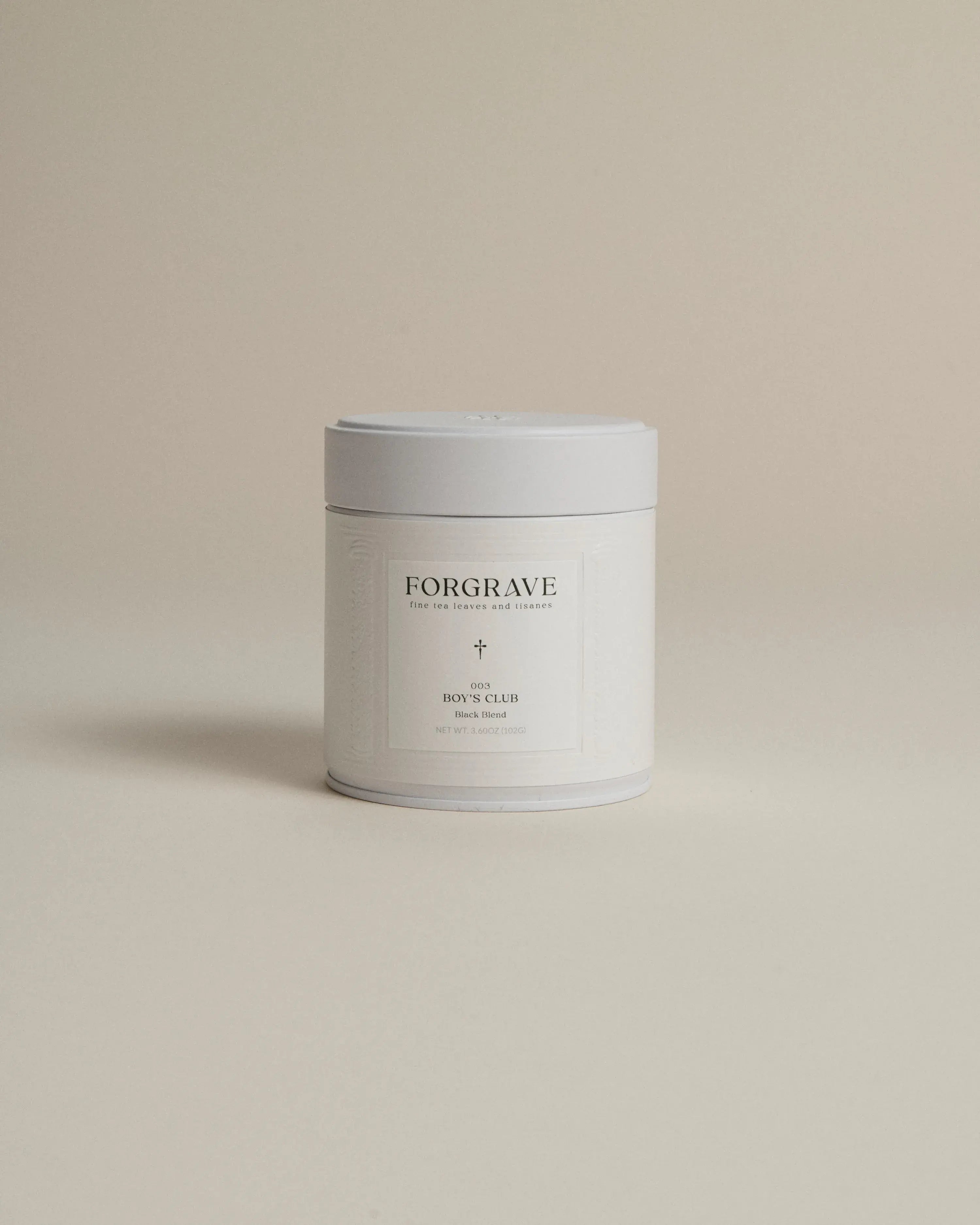 White tea canister labeled ‘003 Boy's Club Black Blend’ on a beige background.