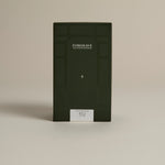 Dark green box labeled ‘FORGRAVE Fine Tea Leaves and Tisanes, 003 Black Blend Boy's Club on a beige background.