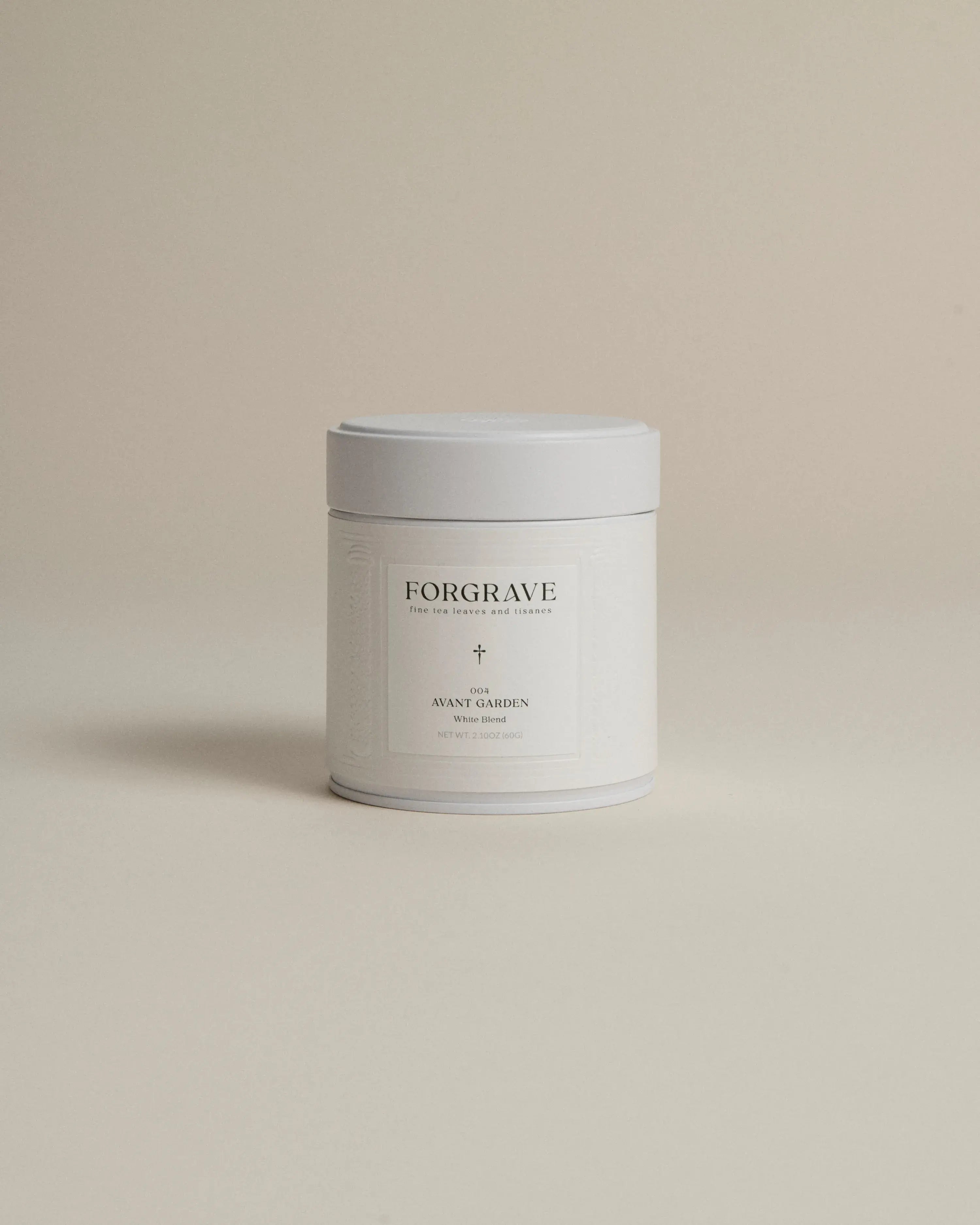 White tea canister labeled ‘004 Avant Garden White Blend’ on a beige background.