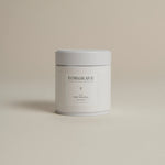 White tea canister labeled ‘005 Mint Mantra Herbal Blend’ on a beige background.