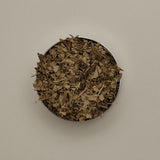 Open Forgrave Augusta Medium Caddy viewed from above, filled with organic loose leaf tea — dried whole leaves and stems in a refillable tin