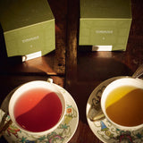 Forgrave Botticelli Duo brewed in vintage porcelain, 006 Primavera in pink hibiscus liquor and 007 Birth of Venus in amber green tea, with sage Forgrave caddies above