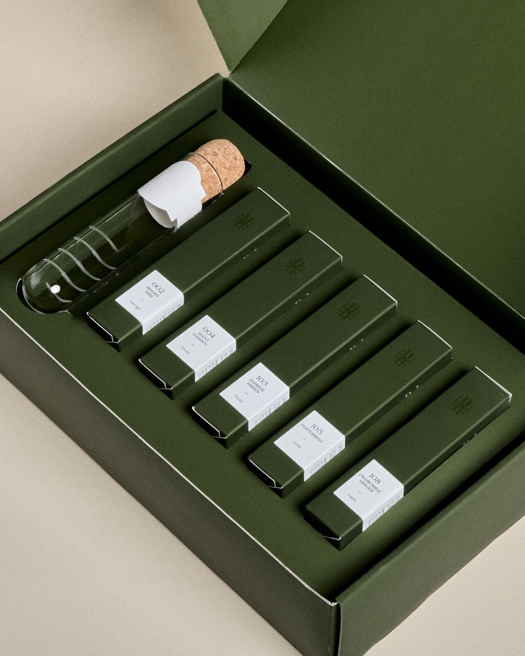 Open Forgrave discovery gift set showing five tea blend cartons and a glass cigar tea infuser